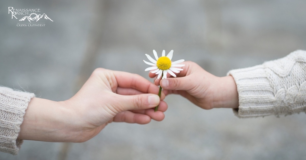 Benefits of Cultivating Gratitude- Addiction Treatment in Ogden Woman Giving a Flower to a Child