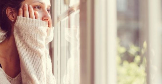 Depression and the Warning Signs of Suicide - Addiction Treatment in Ogden Woman looking thru window - Depression and the Warning Signs of Suicide